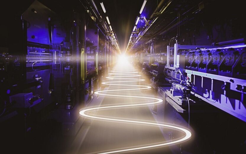 abstarct image of light trail traveling down hallway filled with equipment